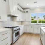 Finished Palm Beach County Florida kitchen remodel with tile backsplash, quartz counters and gold hardware